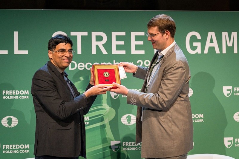 Timur Turlov and Viswanathan Anand on stage at a chess event